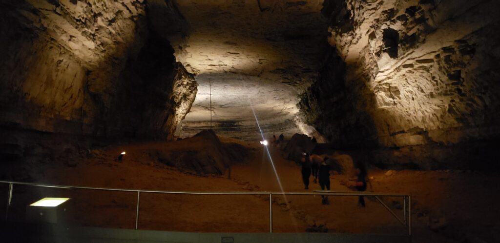 A massive room with people very small in the distance at Mammoth Cave