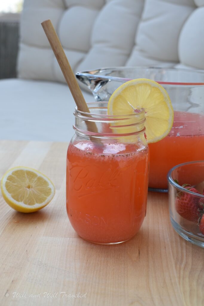 Fresh strawberry lemonade in a mason jar with a lemon attached, a great paleo camping meal