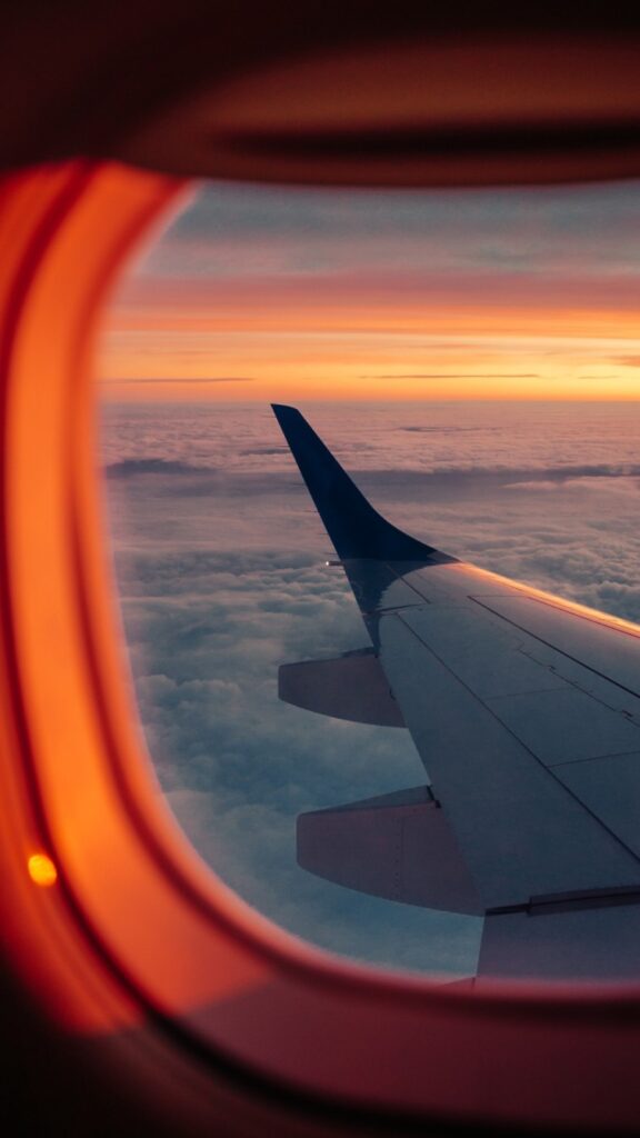 The wing of a plane looking out of an airplane window