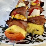 Paleo Hawaiian Skewers with ham, pineapple, bell peppers, and more on a plate