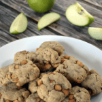 Apple cookies on a plate with slices of green apple behind them