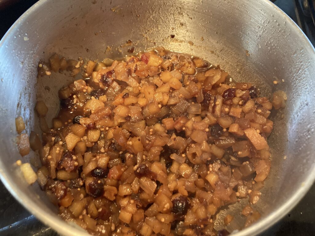 The same ingredients on the stove almost fully cooked in this apple chutney recipe