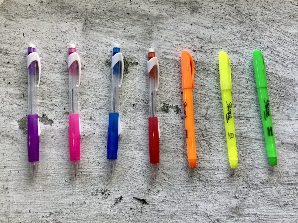 Mechanical pencils and highlighters all lined up like a rainbow of colors