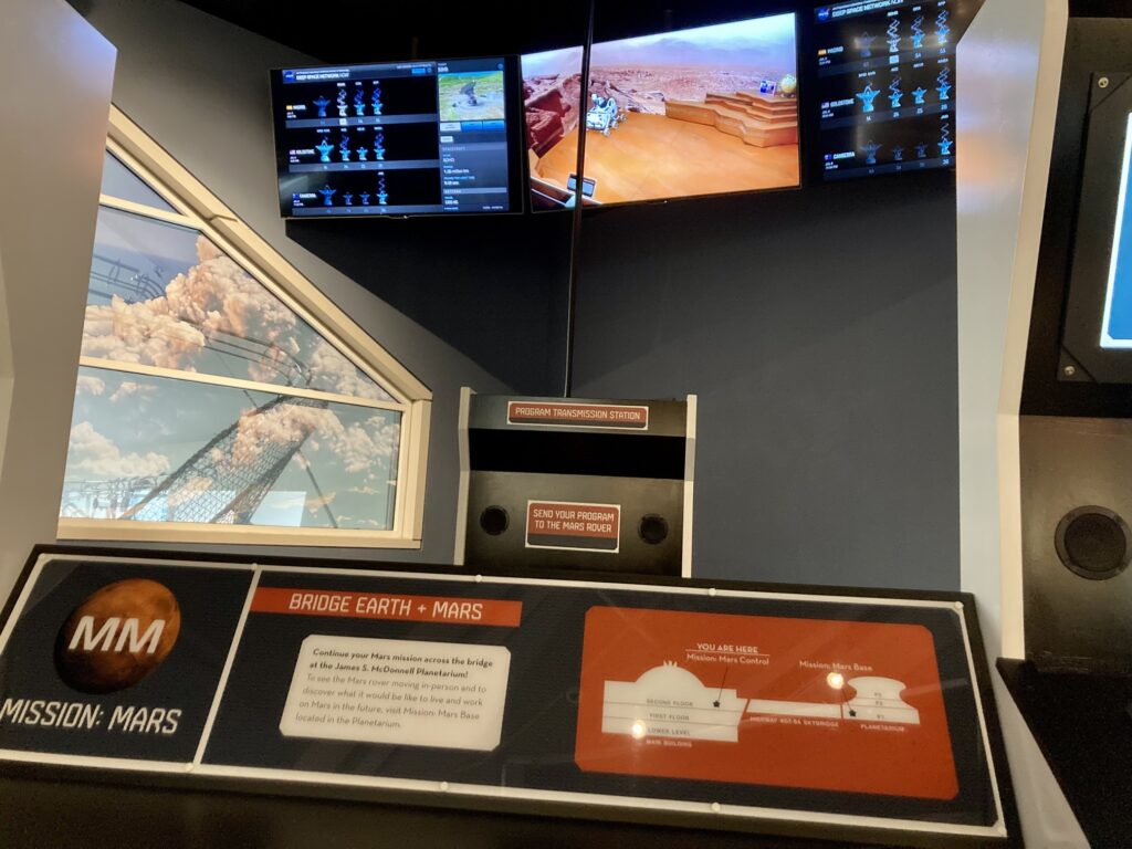 A simulated mission control station exhibit with the landscape of Mars on the TV at the Science Center, one of many family-friendly attractions in St. Louis