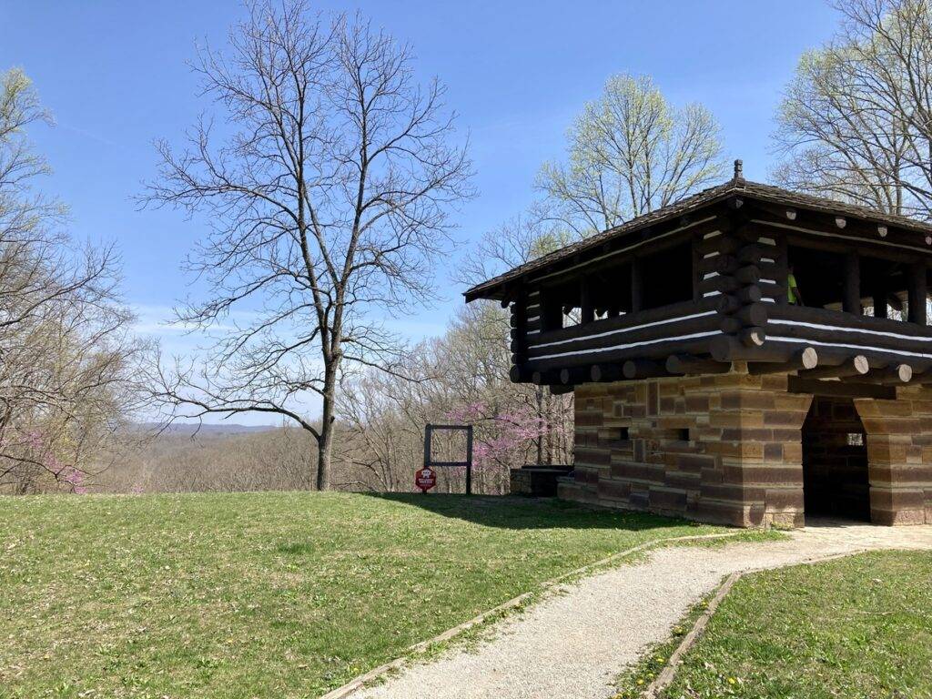 A lookout tower made of logs and stones looking over the scenic view at Brown County