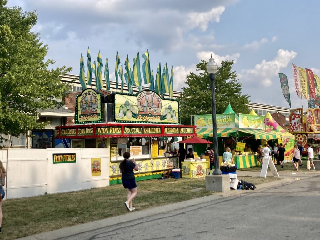 A food vendor selling vegetables at the state fair, allowing visitors to be eating healthy at the state fair