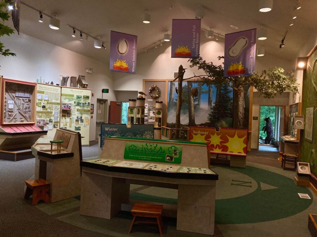 Mounds State Park visitor's center with tables for kids and posters on the wall. A big fake tree is in the background