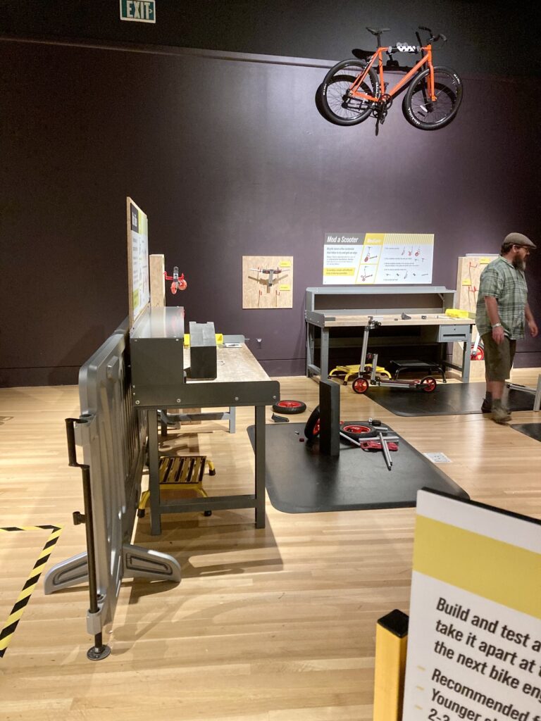 An interactive area at the Indiana State Museum for visitors to try their hand at putting together parts to make a bicycle.
