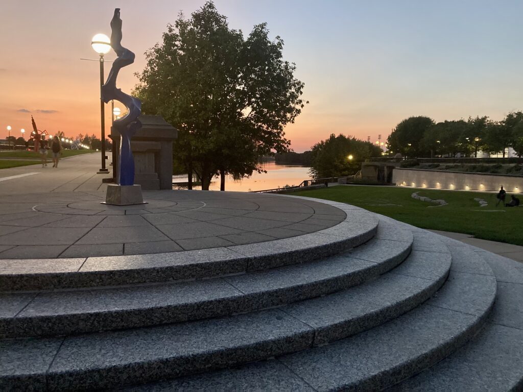 A sunset over the steps over the bridge and water at White River State Park