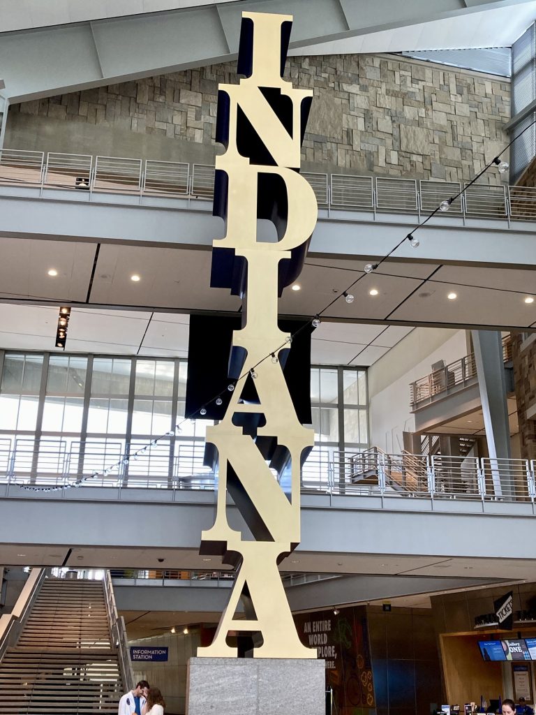 A sign with Indiana written vertically inside the Indiana State Museum