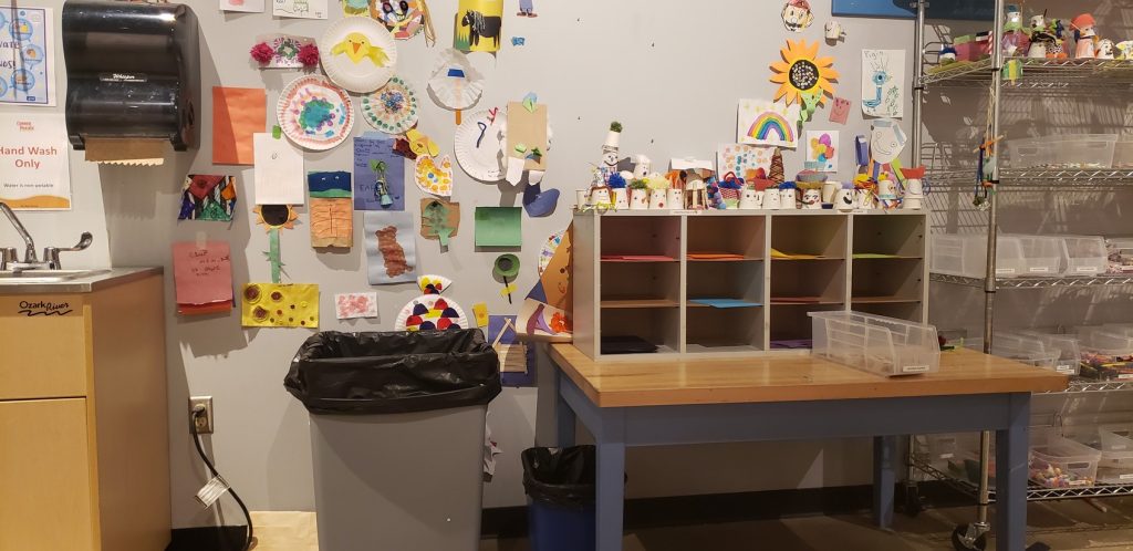 The indoor craft area at Conner Prairie. There are various art projects hanging on the wall