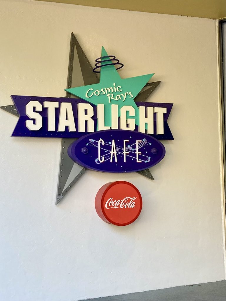 The logo of Cosmic Ray's Starlight Cafe, a great gluten-free and dairy-free restaurant at Magic Kingdom