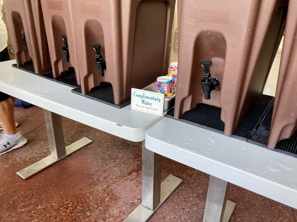 Complimentary water is a great way to save money at Disney World. This water jug station is outside of Casey's Corner in Magic Kingdom