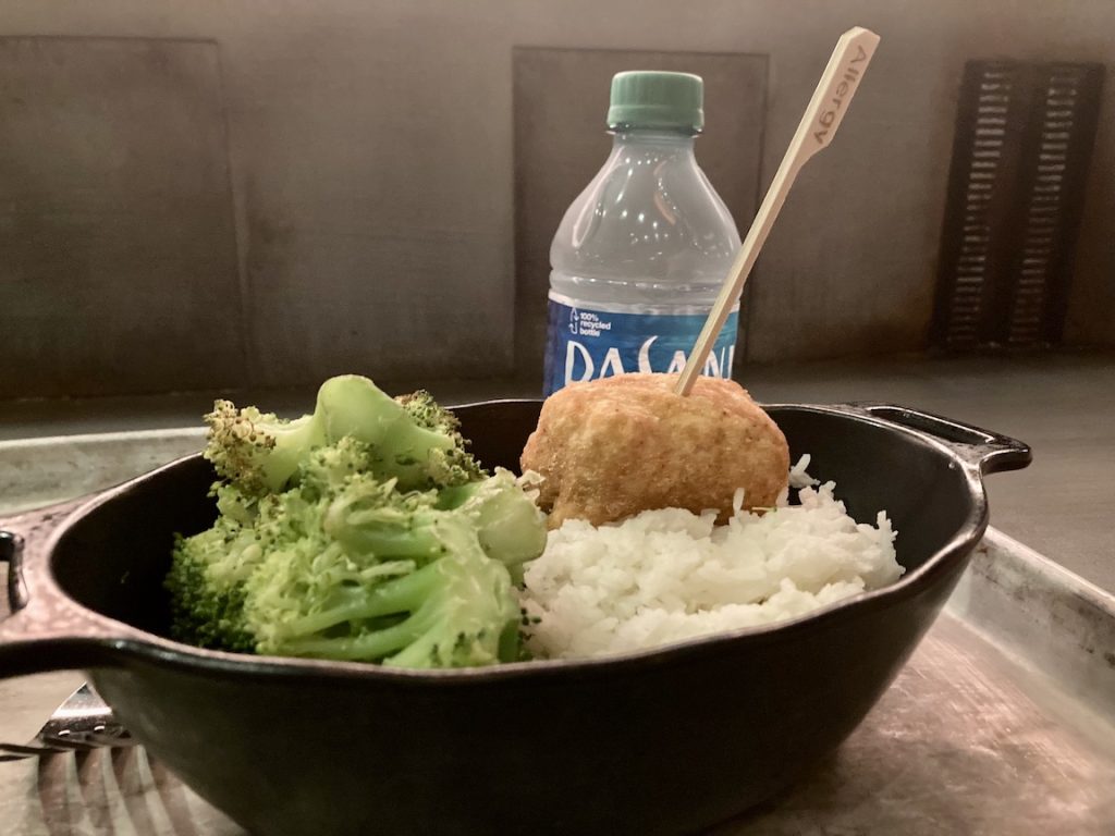 Kid's meal at Docking Bay 7 with a chicken nugget or meatball, rice, and broccoli with water
