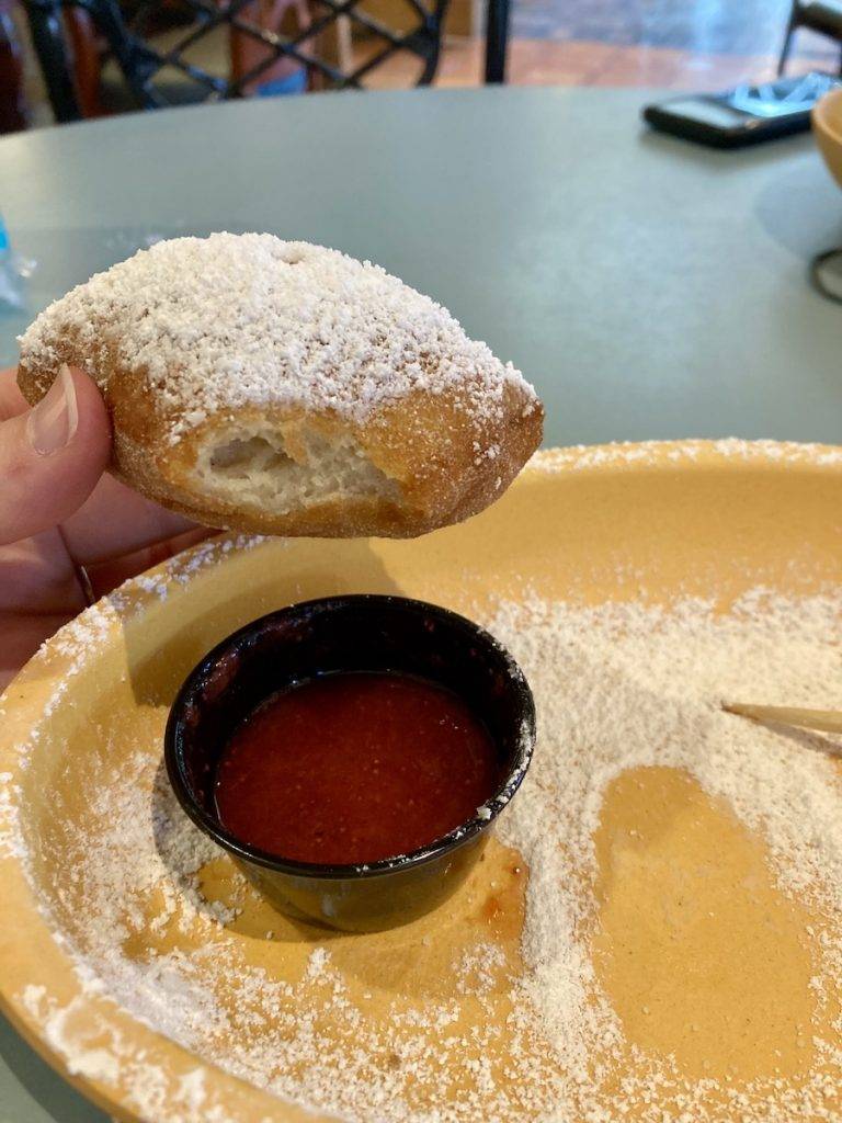 A gluten-free beignet at Disney World with strawberry dipping sauce